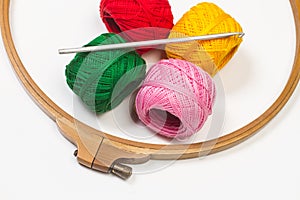 Colored yarn spools and a crochet hook