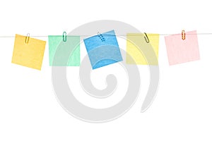 Colored yellow, green, blue, red stickers with paper clips hanging on a rope