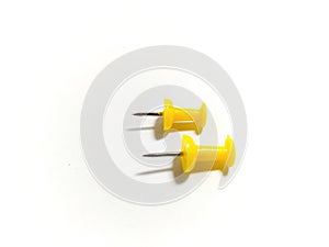 Colored yellow push pins isolated on white background