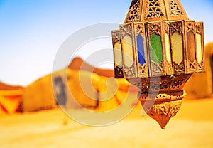 Coloreful berber lamp with traditional nomad tents on background