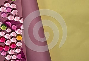 colorful 3d glass balls on pink paper that you unwrap next to the yellow part of the background