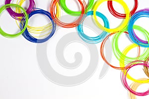 Colorful 3d pen filaments on white background, top view