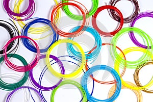 Colorful 3d pen filaments on white background, top view