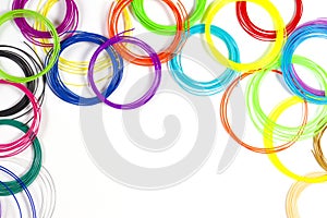 Colorful 3d pen filaments on white background, top view