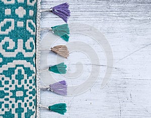 Colorful able runner with tassels on a white rustic table