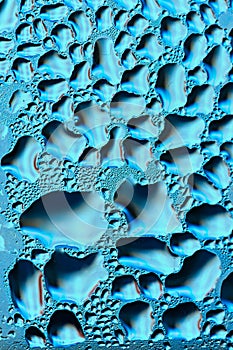Blue colorful abstract background. Beautiful macro shot of water drops on a window