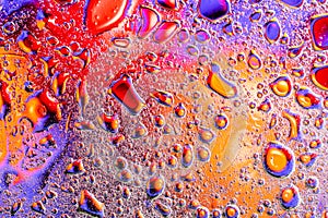 Colorful abstract background. Water drops rainbow colors on glass. Amazing abstract water drops on glass texture or background