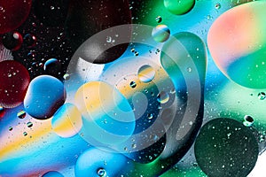 Colorful abstraction of oil bubbles in water. View from above. Macro photography