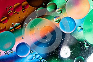 Colorful abstraction of oil bubbles in water. View from above. Macro photography