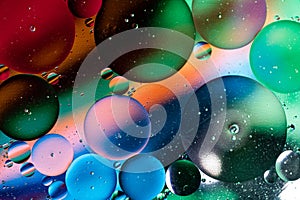 Colorful abstraction of oil bubbles in water. View from above. Macro photography