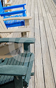 Colorful Adirondack deck and beach chairs in bright blue beige a