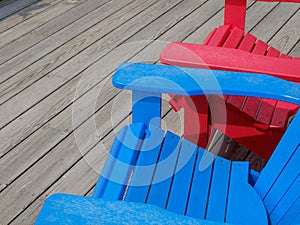 Colorful Adirondack deck and beach chairs in bright red and brig