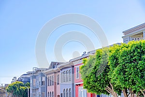 Colorful adjacent residential buildings with paned windows at San Francisco, CA