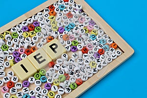 Colorful alphabet beads and square letters with text INDIVIDUALIZED EDUCATION PROGRAM