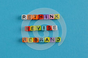 Colorful alphabet beads with text RETHINK, REVISE and REBRAND