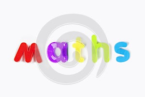 Colorful alphabet magnets spelling `maths` over white background