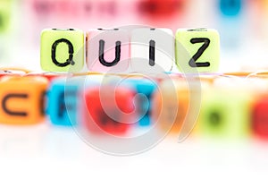 colorful alphabet word cube of QUIZ on white