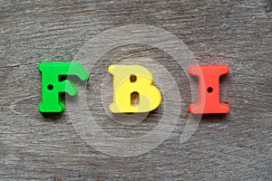 Colorful alphabet in word FBI Abbreviation of Federal Bureau of Investigation on wood background
