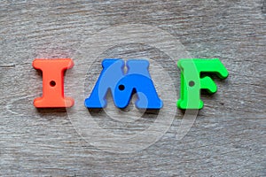 Colorful alphabet in word IMF Abbreviation of International Monetary Fund on wood background