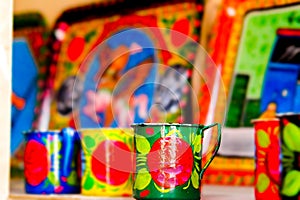 colorful ancient cup with green, yellow, blue and red colors with scenery