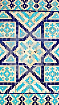 Colorful ancient traditional Uzbek pattern on the ceramic tile on the wall of the mosque