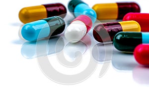 Colorful antibiotic capsule pills on white background. Pharmaceutics concept. Antibiotic drug resistance. Pharmaceutical industry.