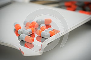 Colorful of antibiotic capsules pills with shadows on stainless steel drug tray