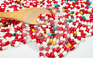 Colorful of antibiotic capsules pills and wood spoon