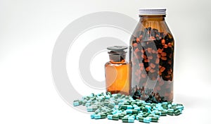 Colorful of antibiotic medicine capsule pills and two amber bottles, drug resistance