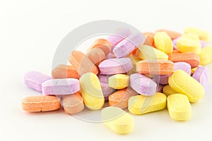 Colorful antibiotic tablets on white