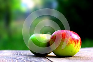 Colorful apples on wooden desk board with copyspace for you text or logo.