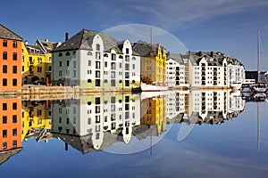 Colorful architecture of Alesund reflected in the water, Norway