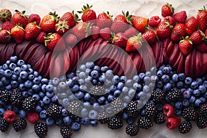 A colorful arrangement of strawberries, sliced red apples, and various berries, arranged in a wave-like pattern on sand.
