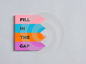 Colorful arrow shaped stickers with the message fill in the gap