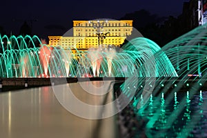 Colorful artesian fountains at Unirii Square in Bucharest city.