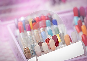 Colorful artificial Nails in nail salon shop. Set of false nails for customer to choose color for manicure or pedicure in nail