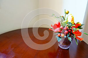 Colorful Artificial Yellow Orange Rose Vase on Wooden Table and