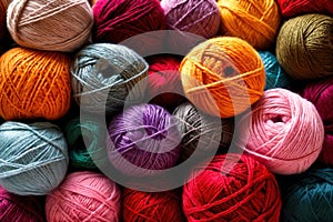 Colorful assorted variety of balls of thick knitting yarn, background texture