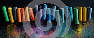 The colorful assortment of chalks on a dark artistic background. AI generated image photo