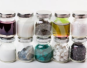 Colorful assortment of jars filled with various substances on a white background