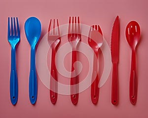 Colorful Assortment of Plastic Utensils Isolated on a Pink Background Spoons, Forks, and Knives for Parties and Picnics