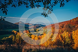 Colorful autumn landscape in the mountain village. Foggy morning in the Carpathian mountains