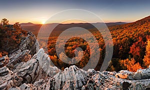 Colorful autumn landscape in the mountains with red forest, Sunset