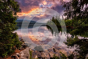 Colorful Autumn landscape under warm Sunlit. Majestic mountain lake in National Park High Tatra at sunset. Dramatic unusual scene