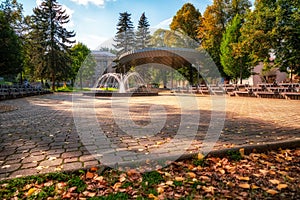 Colorful autumn leaves and fountain in autumn park in town Ruzomberok, Slovakia