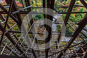 Colorful autumn scene throug wooden scaffolding for restoration works at Kiyomizu-dera Buddhist Temple. Kyoto, Japan