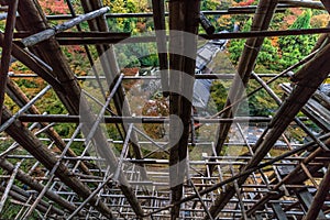 Colorful autumn scene throug wooden scaffolding for restoration works at Kiyomizu-dera Buddhist Temple. Kyoto, Japan