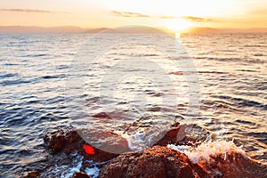 Colorful autumn sunrise on rock beach. Dramatic morning scene of the Ionian Sea, Corfu island location, Greece, Europe