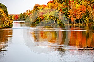 Colorful autumn trees reflecting off of the Wisconsin River in Merrill, Wisconsin