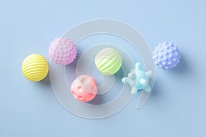 Colorful baby bathing toys on blue table. Flat lay, top view